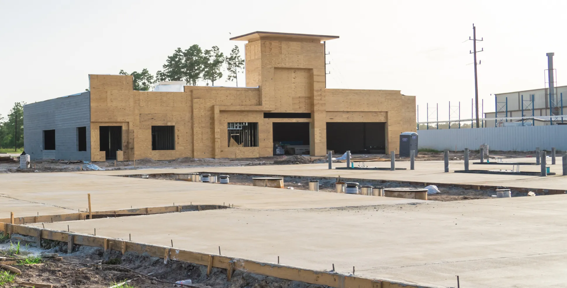 Freshly poured commercial concrete foundation slab during early-stage construction