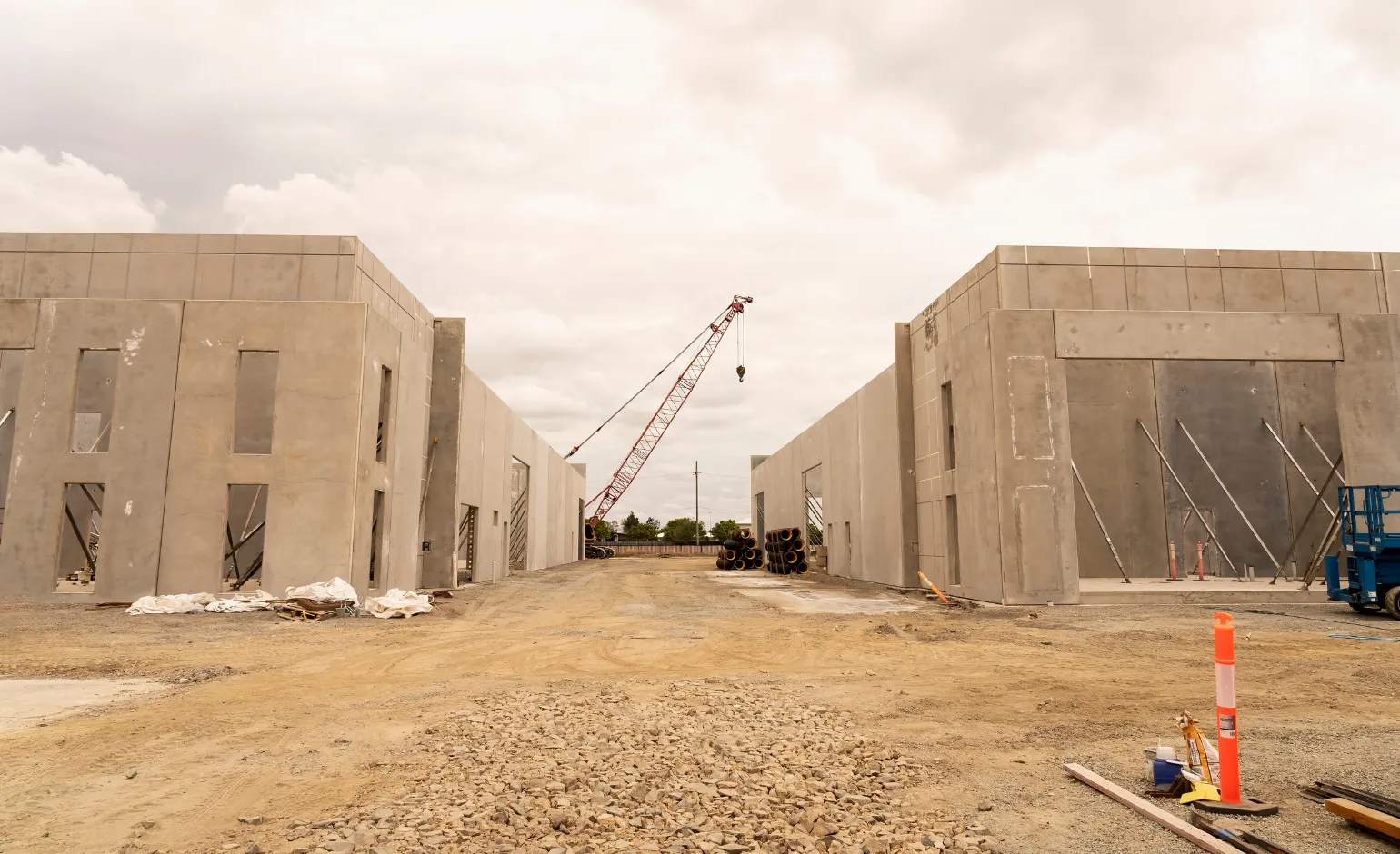 Commercial tilt-up concrete panels being lifted and supported during large-scale construction