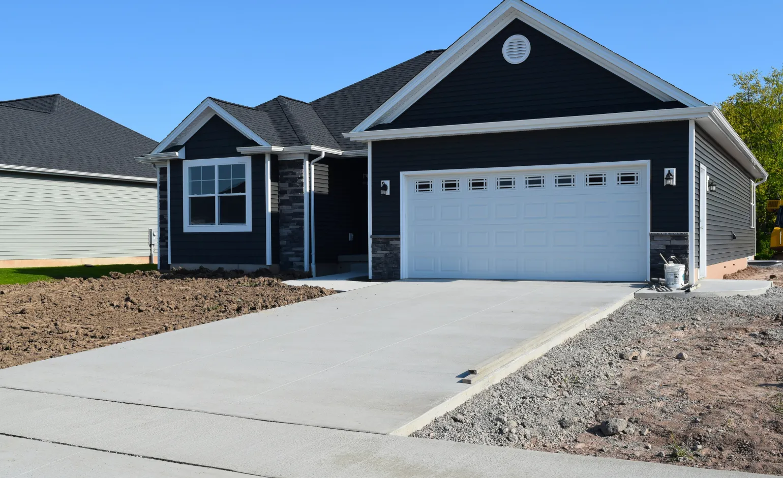 New residential concrete driveway installation in front of modern home